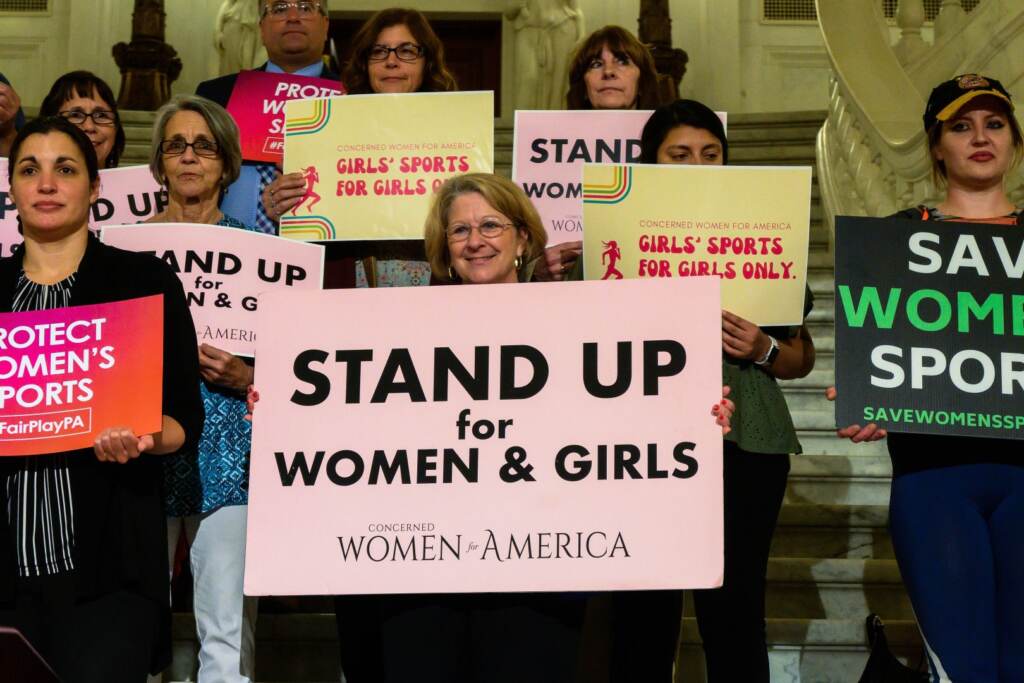 concerned-women-for-america-rally-SPA-01-061422 Supports of Pa. legislation that would ban trans student athletes from participating on teams corresponding with their gender hold up signs that say, ''Stand up for women and girls''