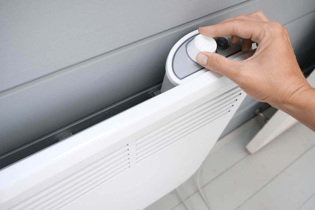 Hand Regulating, Setting Temperature On Electric Convector, Heat The LIHEAP program can help residents pay their heating bill. (Mikhalitskaia / BigStock)