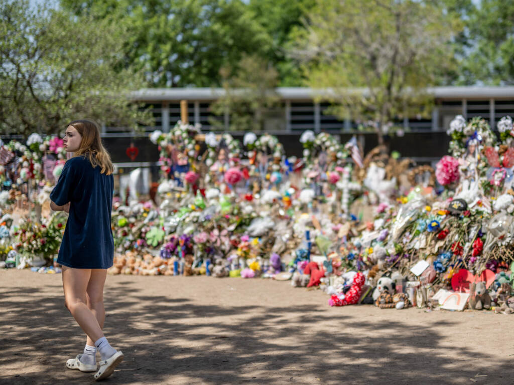 A young woman pays her respects at a memorial in front of Robb Elementary School earlier this monthin Uvalde, Texas. Committees have begun inviting testimony from law enforcement authorities, family members and witnesses regarding the mass shooting at Robb Elementary School which killed 19 children and two adults. A young woman pays her respects at a memorial in front of Robb Elementary School earlier this monthin Uvalde, Texas. Committees have begun inviting testimony from law enforcement authorities, family members and witnesses regarding the mass shooting at Robb Elementary School which killed 19 children and two adults. (Brandon Bell/Getty Images)
