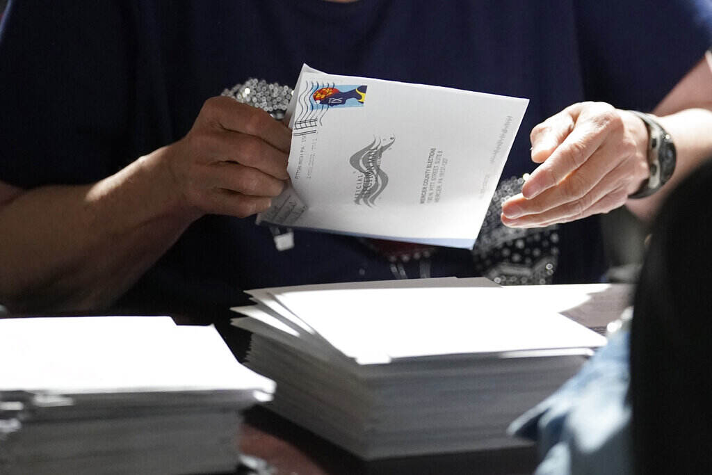 Election 2022 Pennsylvania Senate A close-up of someone handling a mail-in ballot.