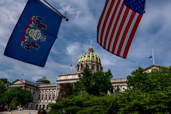 Flags are seen above the Pennsylvania State Capitol building.