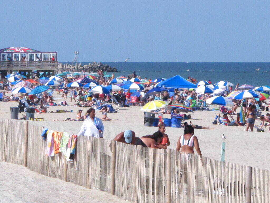 Jersey Shore Pop Up Parties Beachgoers are seen on the beach at the Jersey Shore, with the ocean in the background.