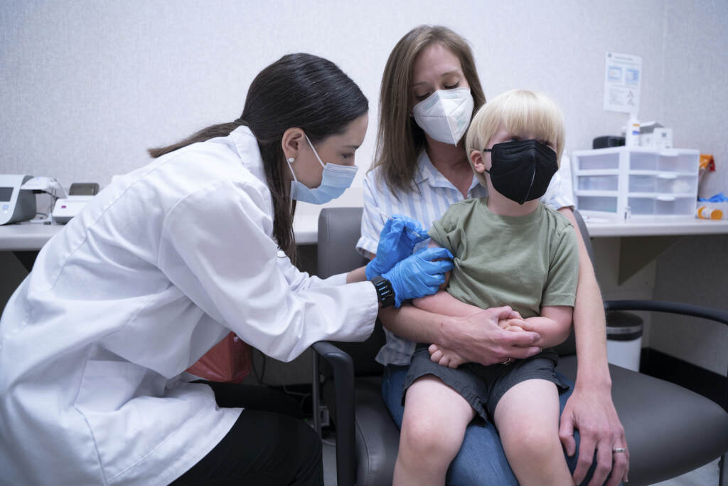 Virus Outbreak-Vaccines-Kids Pharmacist Kaitlin Harring, left, administers a Moderna COVID-19 vaccination to 3-year-old Fletcher Pack