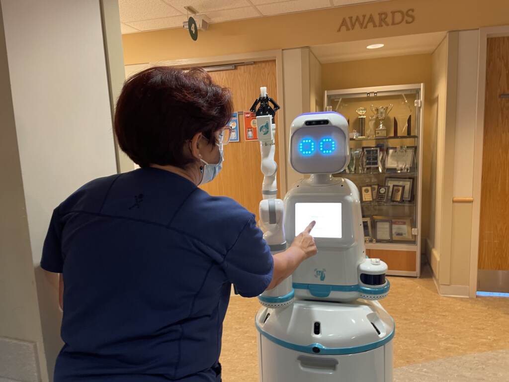 moxi-cobot-christiana-delaware-c-barrish-2022-06-28-9 Nurse Tina Merritt engages with Moxi in her cardiac unit at Christiana Hospital.