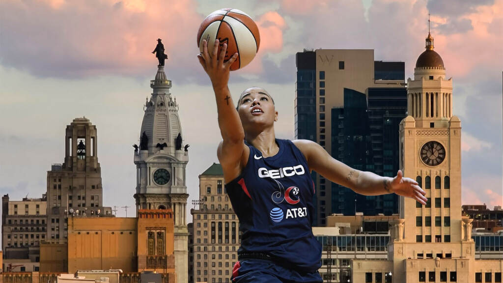 Mystics Cloud Basketball The Mystics' Natasha Cloud lifts up a basketball with the Philadelphia skyline in the background.