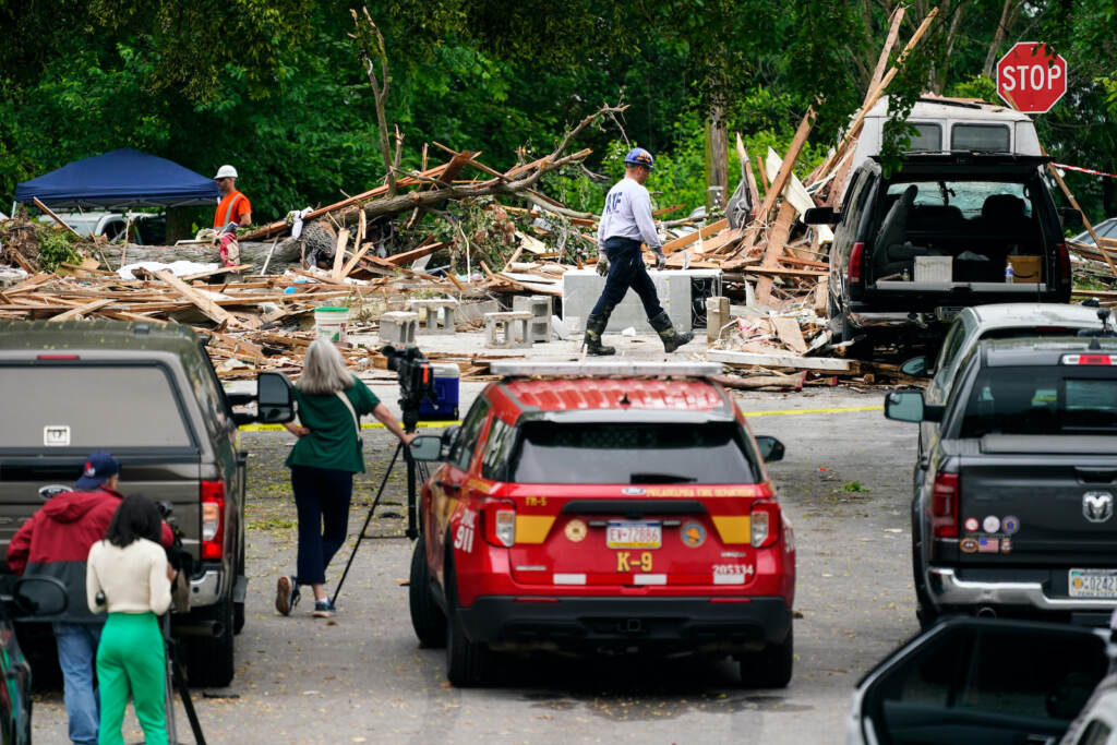 Fatal Home Explosion An investigator, center top, moves through the scene of a deadly explosion in a residential neighborhood in Pottstown