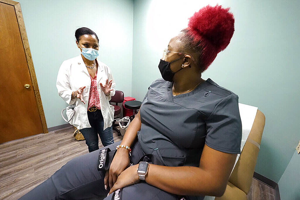 Felecia Brown, Kamiko Farris A doctor speaks with her patient.