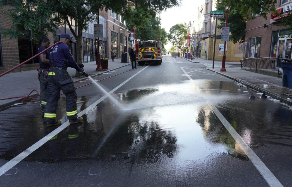 Philadelphia Shooting A Philadelphia firefighter washes blood off the sidewalk at the scene of a fatal overnight shooting on South Street in Philadelphia, Sunday, June 5, 2022. (AP Photo/Michael Perez)
