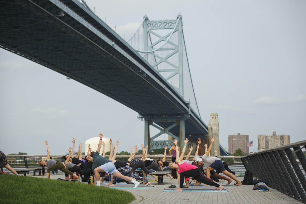 1806_drwc_yoga-0390 Wellness on the Waterfront, a summer series of free outdoor exercise classes on the Race Street Pier, is back for a full season of yoga and pilates. (Photo courtesy of Delaware River Waterfront Corporation)