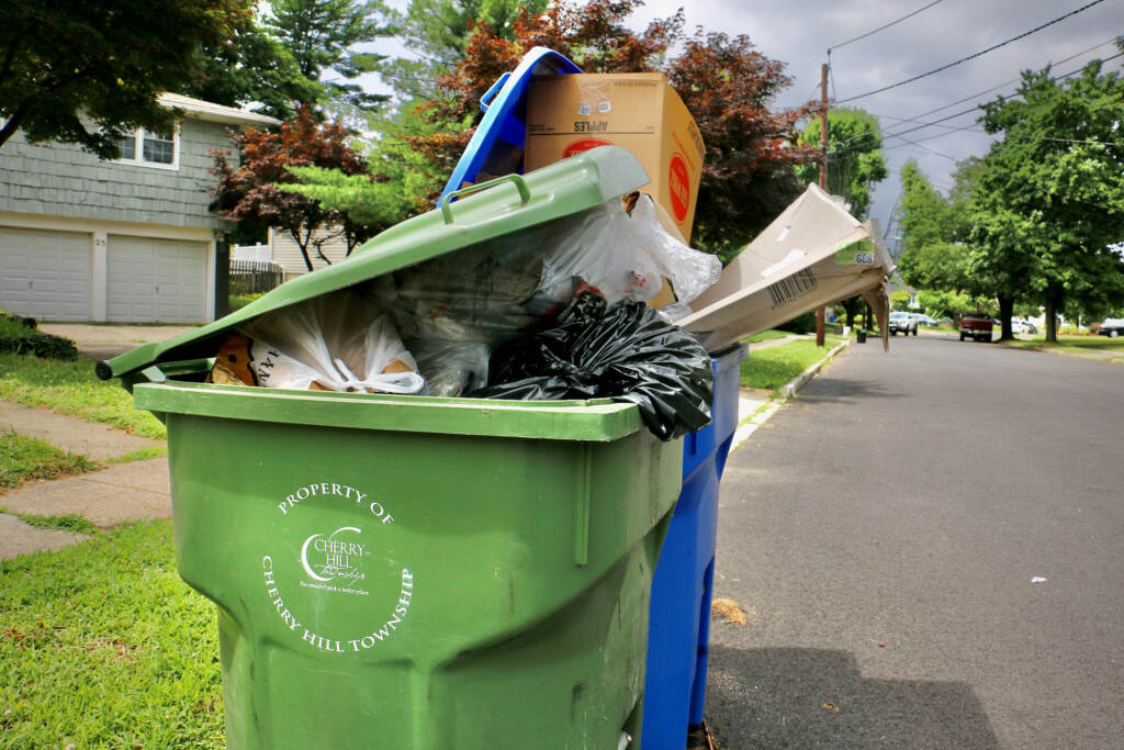 2022 07 07-e lee-cherry hill nj-garbage collection woes overflow Garbage and recycling containers overflow on a residential street in Cherry Hill Township, New Jersey. (Emma Lee/WHYY)