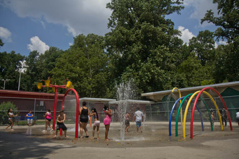 Families enjoy the sprinklers at Ferko Playground
