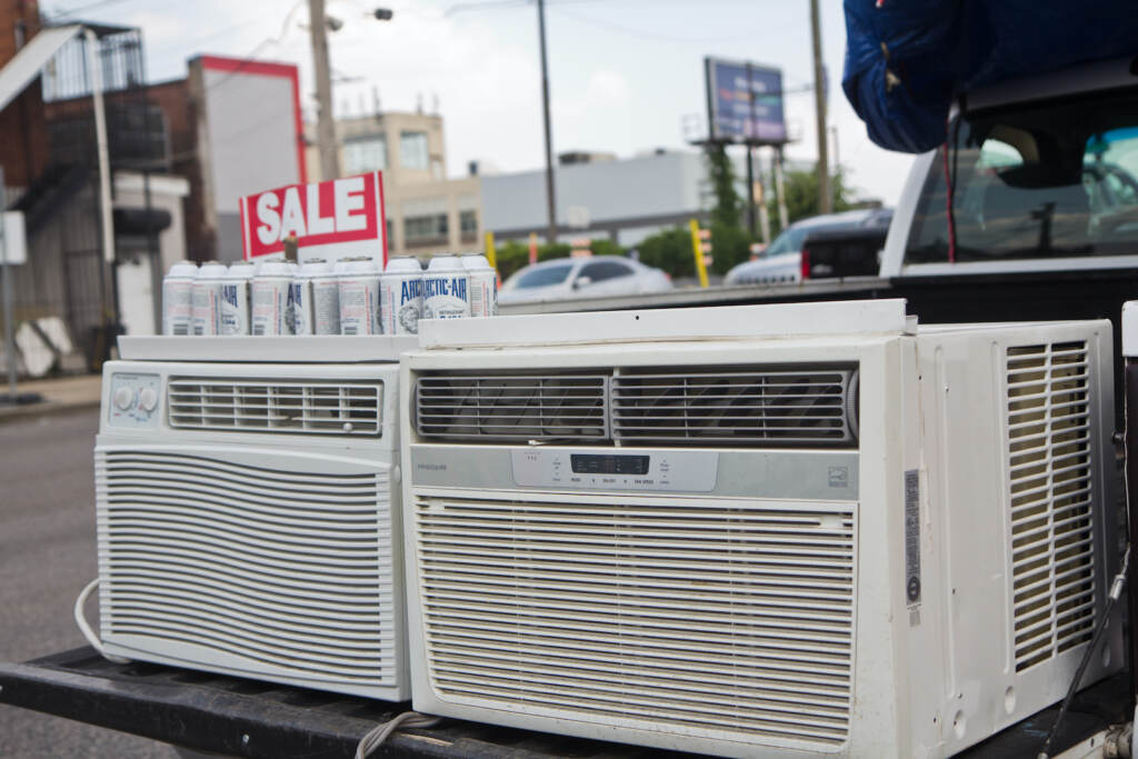 AC units for sale on the back of a pick-up truck