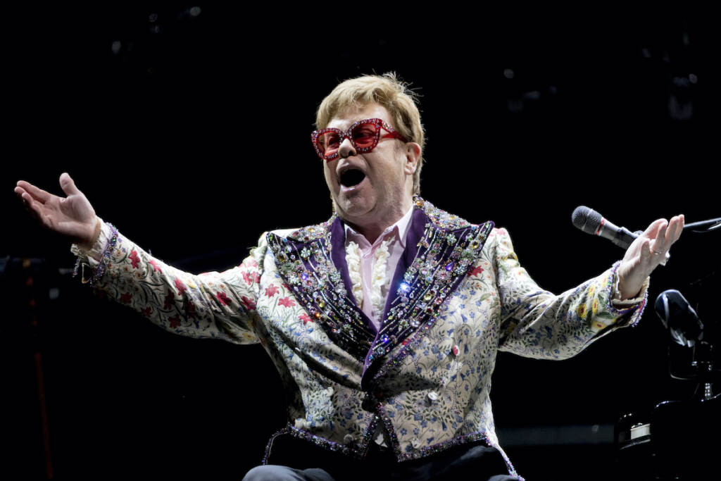 Elton John Elton John gestures during a performance