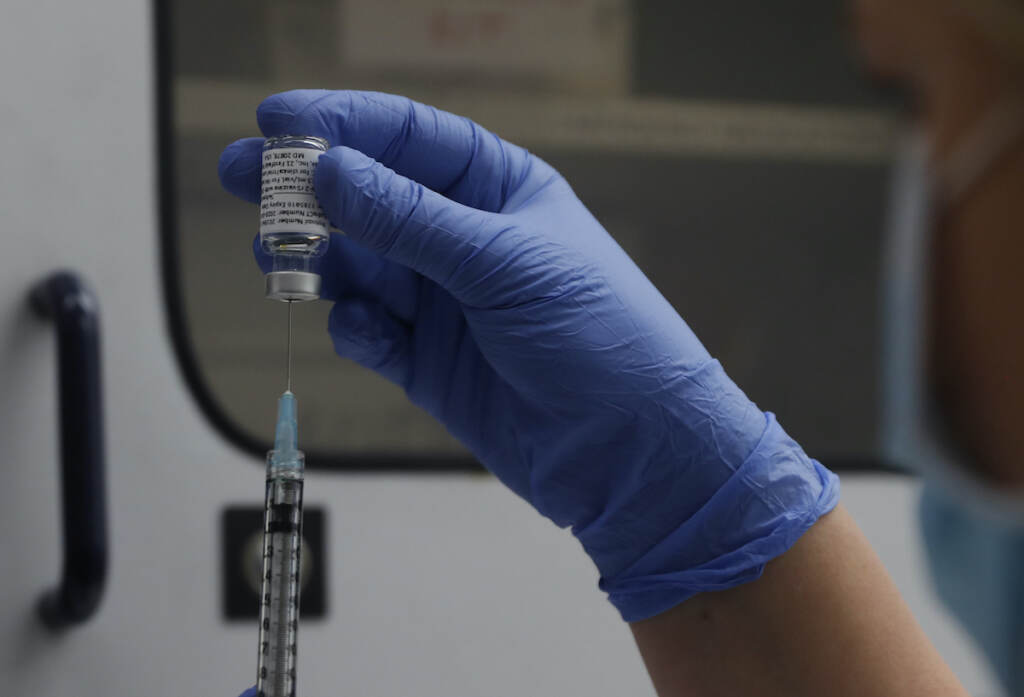 Virus Outbreak Military Vaccines File photo: A vial of the Phase 3 Novavax coronavirus vaccine is seen ready for use in the trial at St. George's University hospital in London, Oct. 7, 2020. (AP Photo/Alastair Grant, File)