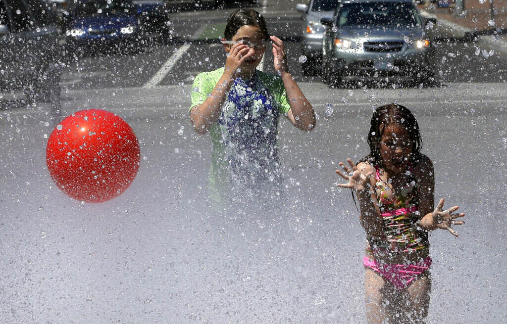 Climate Change Youth Mental Health Children play in a fountain. Health officials say that the impacts of climate change, including more devastating wildfires, heatwaves, drought and poor air quality. (AP Photo/Don Ryan, File)