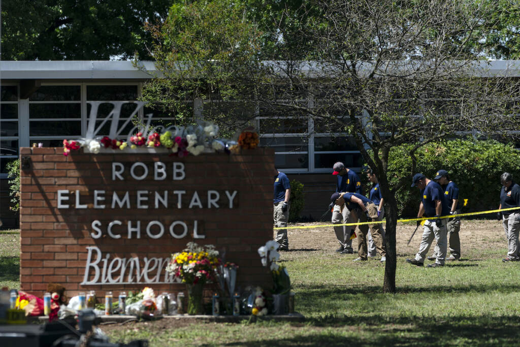 File photo: Investigators search for evidences outside Robb Elementary School in Uvalde, Texas, May 25, 2022, after an 18-year-old gunman killed 19 students and two teachers. (AP Photo/Jae C. Hong, File)