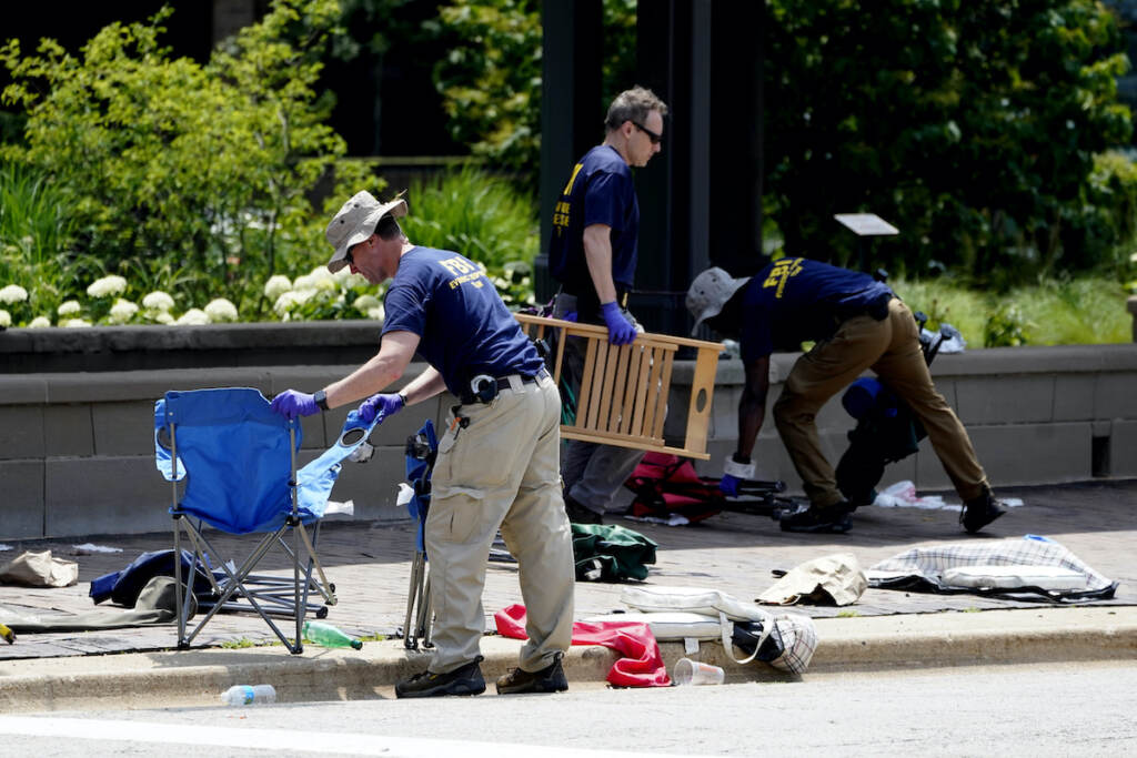 Shooting July Fourth Parade Members of the FBI's evidence response team remove personal belongings one day after a mass shooting in downtown Highland Park, Ill., Tuesday, July 5, 2022. (AP Photo/Charles Rex Arbogast)