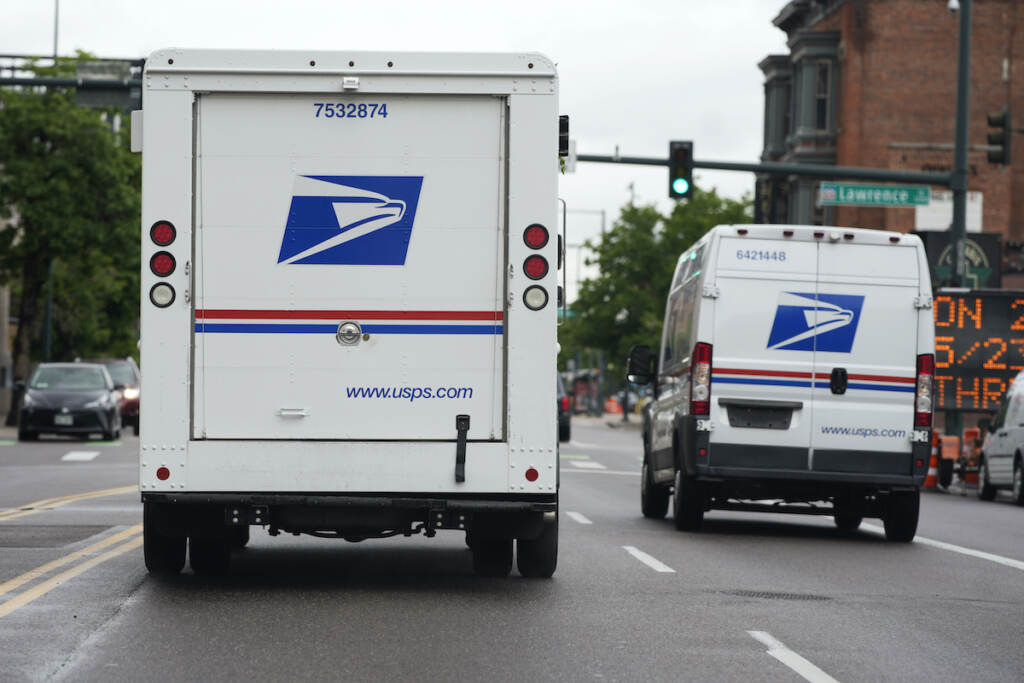 Postal Service Vehicles A USPS logo adorns the back doors of United States Postal Service delivery vehicles