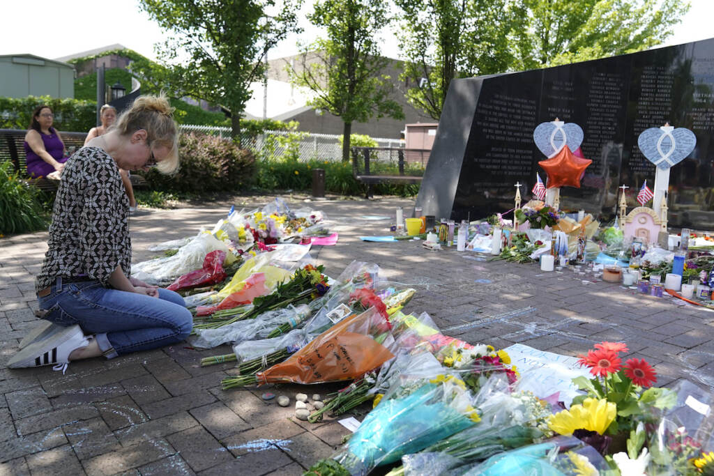 File photo: A visitor prays at a memorial to the seven people killed and others injured in the Fourth of July mass shooting at the Highland Park War Memorial in Highland Park, Ill., Thursday, July 7, 2022. (AP Photo/Nam Y. Huh, File)