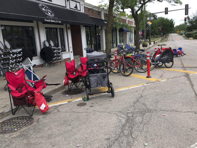 Terrified parade-goers fled Highland Park's Fourth of July parade after shots were fired, leaving behind their belongings as they sought safety, Monday, July 4, 2022, in Highland Park, Ill. (Lynn Sweet/Chicago Sun-Times via AP)