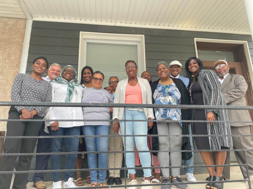 Image from iOS (75) A groups stands in front of Ardella’s House transitional home for formerly incarcerated women located in the 2400 block of N 33rd street. (Cherri Gregg/WHYY)