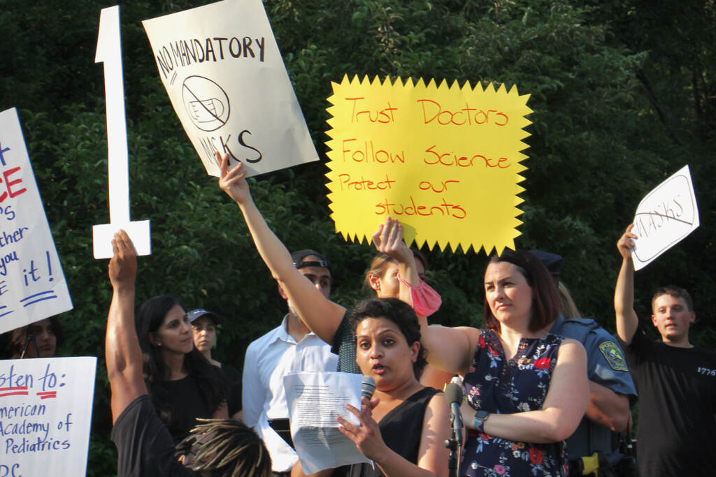 PHOTO2 Anusha Viswanathan, July 27, 2021, speaking at a press conference in support of stricter COVID-19 safety policies, as other Central Bucks parents in the crowd shouted over her. (Emma Lee/WHYY)