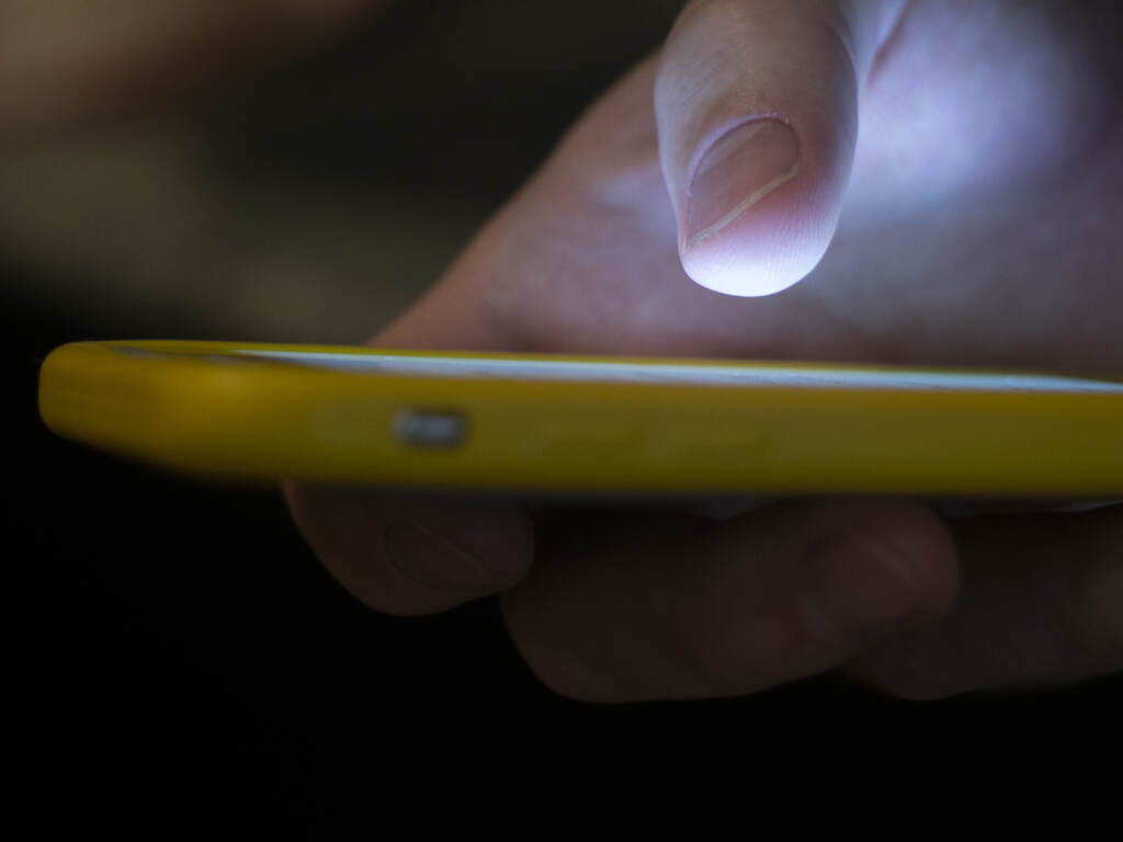 File photo: A man uses a cell phone in New Orleans, Aug. 11, 2019. (AP Photo/Jenny Kane, File)