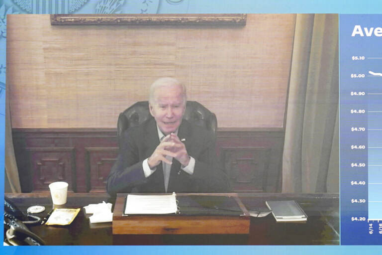 President Biden is seen on screen sitting at a desk.