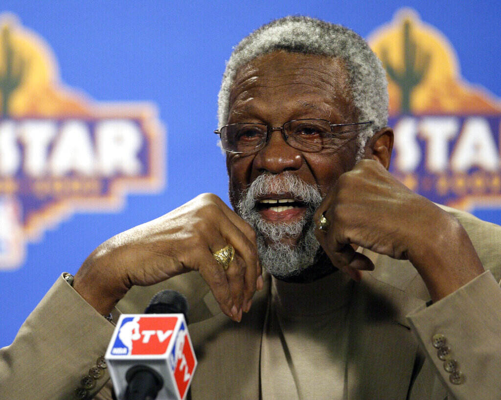 Up-close photo of Bill Russell speaking into a microphone.