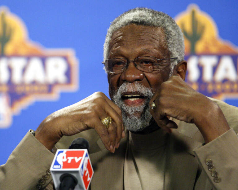 Up-close photo of Bill Russell speaking into a microphone.