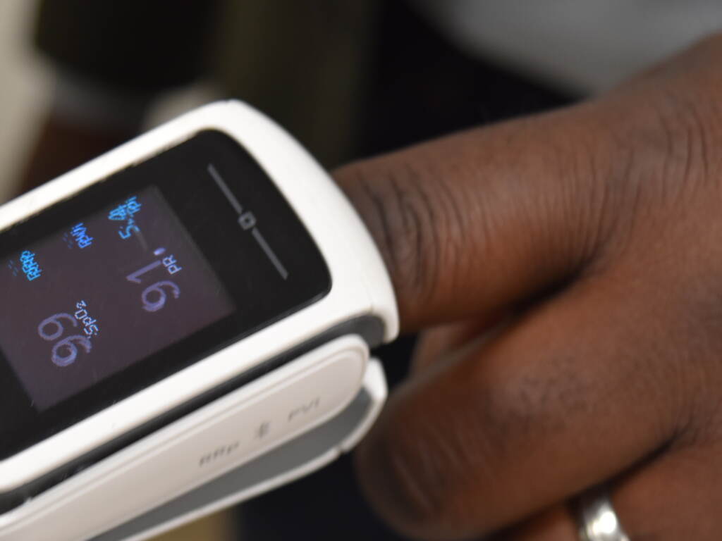 A pulse oximeter is worn by Brown University professor Kimani Toussaint. The devices have been shown in research to produce inaccurate results in dark-skinned people, and Toussaint’s lab is developing technology that would be more accurate, regardless of skin tone. An up-close view of someone using a pulse oximeter.