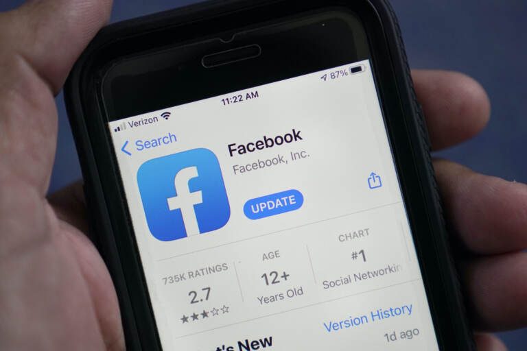 FILE - The Facebook app is shown in the app store on a smart phone in Surfside, Fla., on April 23, 2021. According to a new report from the nonprofit groups Global Witness and Foxglove, Facebook is letting violent hate speech slip through its controls in Kenya as it has in other countries. It is the third such test of Facebook's ability to detect hateful language — either via artificial intelligence or human moderators — that the groups have run, and that the company has failed. (AP Photo/Wilfredo Lee, File)