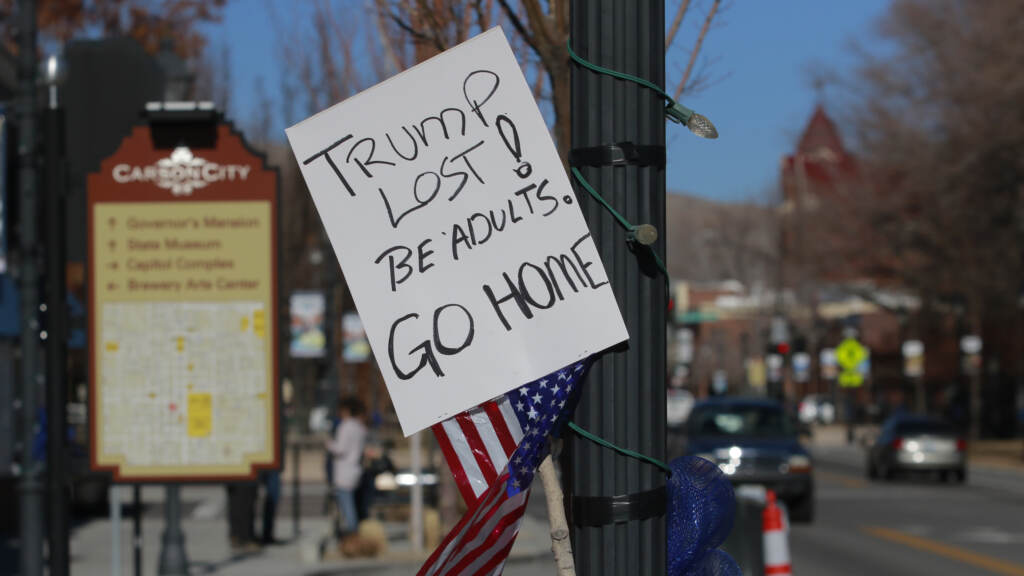A sign in Carson City, Nevada in January 2021 calling on pro-Trump protesters, supporting his baseless claims of election fraud, to go home. Now, other candidates are following in Trump’s footsteps. A sign reads,