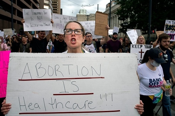 Dr. Kara Beasley protests the overturning of Roe vs. Wade by the U.S. Supreme Court, in Denver, Colorado on June 24, 2022. A doctor holds a sign that reads,