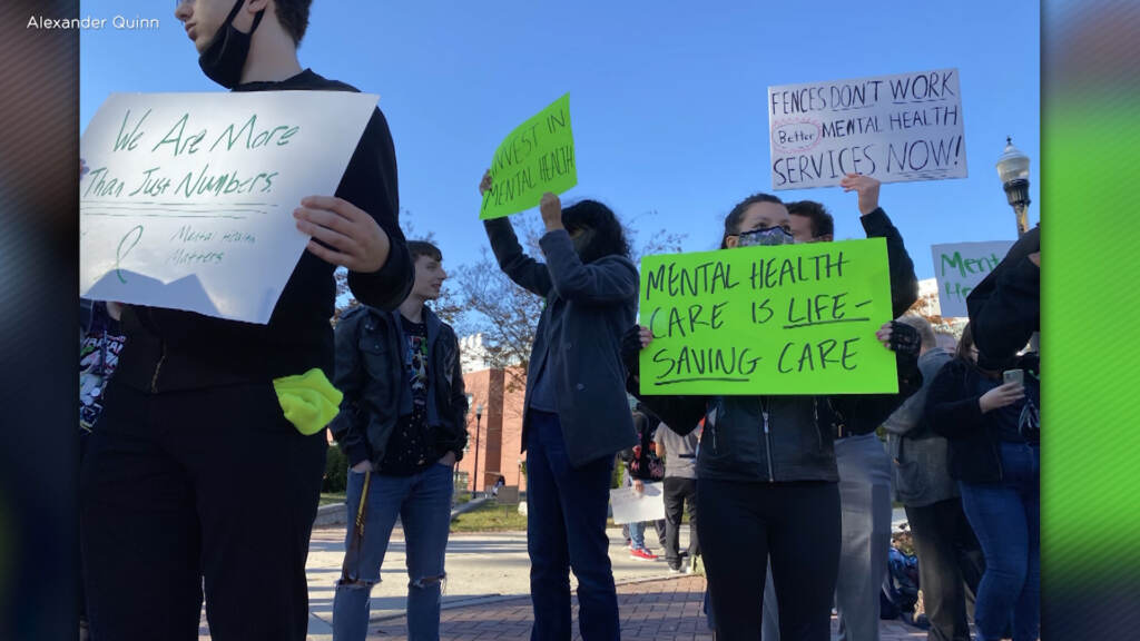 mental-health-rowan-university-nj-colleges-depression-A3005-anxiety People hold signs calling for more mental health support.