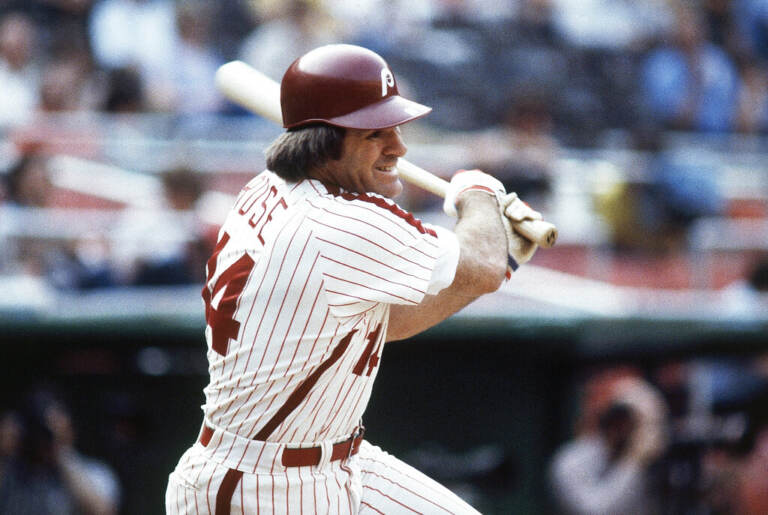 Pete Rose swings a bat.
