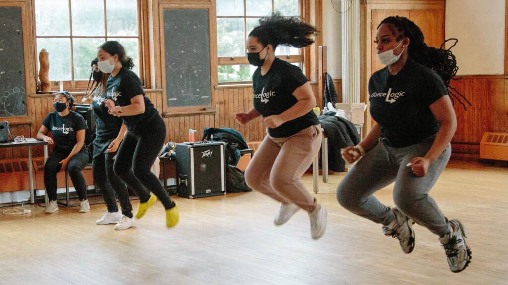 philly-dance-girls-coding Girls jump in the air in a dance class.