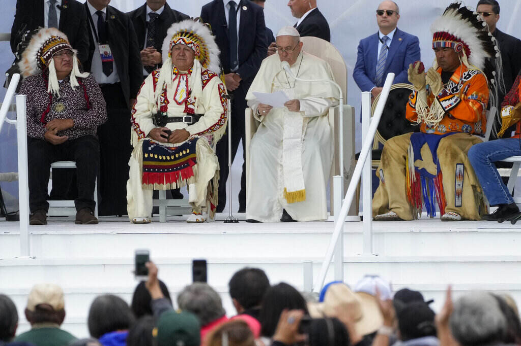 Francis Pope Francis sits on stage with Indigenous leaders from Canada.