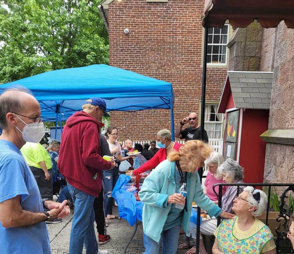 pottstown-churches-violation-notice-1 People gather together, talking and eating.