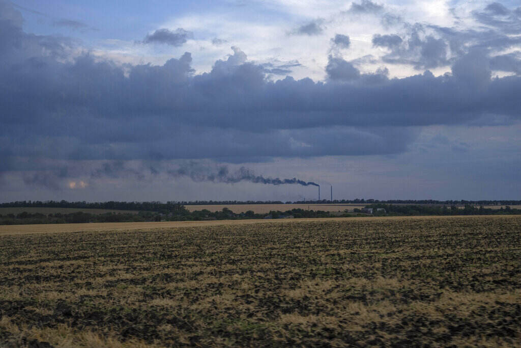 Russia Ukraine War Grain fields backdropped by a power plant in Donetsk region, eastern Ukraine, Friday, July 22, 2022.