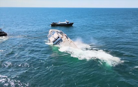 texas-star-artificial-reef The Texas Star sinks into the ocean, foam rising up around it.
