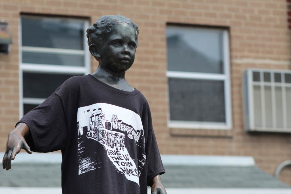 uc-townhomes-encampment-2 A statue is shown wearing a T-shirt.