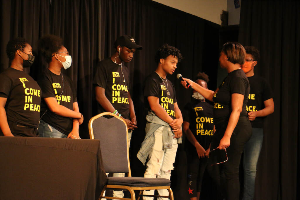 2022 06 24-e lee-monique dudley-philadelphia the rotunda-youth peace corps graduation Monique Dudley, director of career development at House of Umoja, interviews Youth Peace Corps graduates about their goals and plans during a ceremony at the Rotunda in West Phialdelphia. (Emma Lee/WHYY)