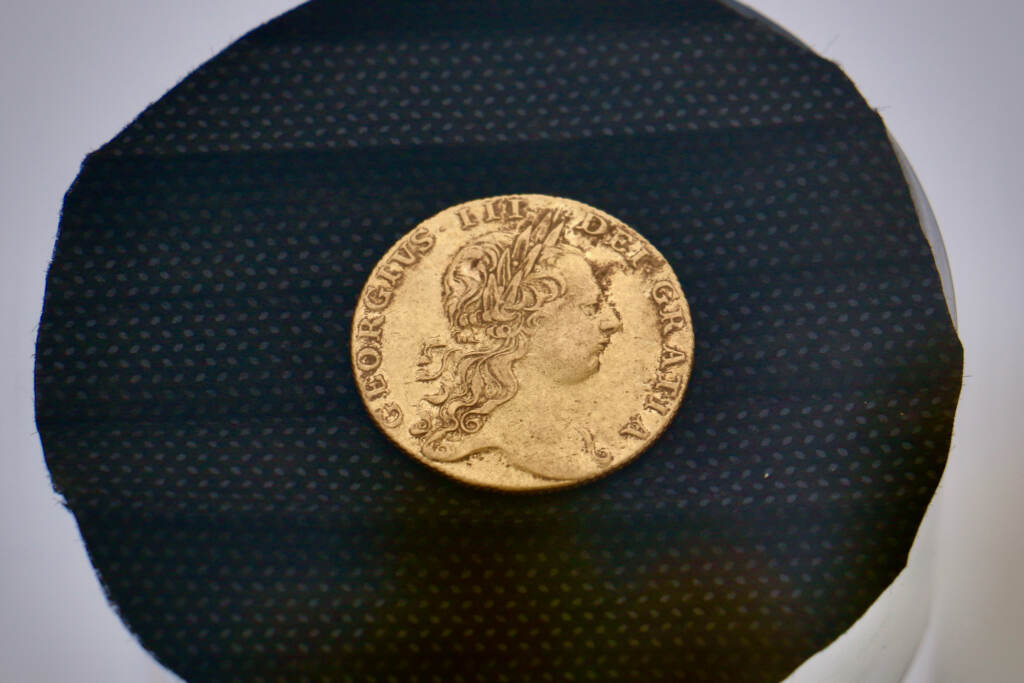 A rare 1776 British gold guinea was discovered on June 18 at the Red Bank Battlefield archaeological site. The remains of 13 men believed to be Hessian soldiers were also discovere there. (Emma Lee/WHYY)