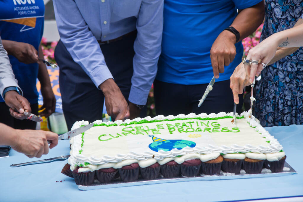 Climate activists held a celebration of the proposed Inflation Reduction Act and protest for more government action on climate change outside Sen. Bob Casey's office in Philadelphia on Aug. 5, 2022. (Kimberly Paynter/WHYY)