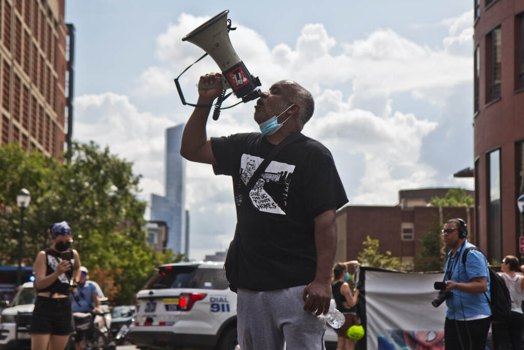 2022 08 08 k paynter sheldon david resident UC townhomes encampment eviction attempt (1 of 1) Sheldon David, a University City Townhomes resident of 13 years, spoke to supporters at a protest march after an attempted eviction of an encampment protesting the displacement of the townhomes' residents on August 8, 2022. (Kimberly Paynter/WHYY)