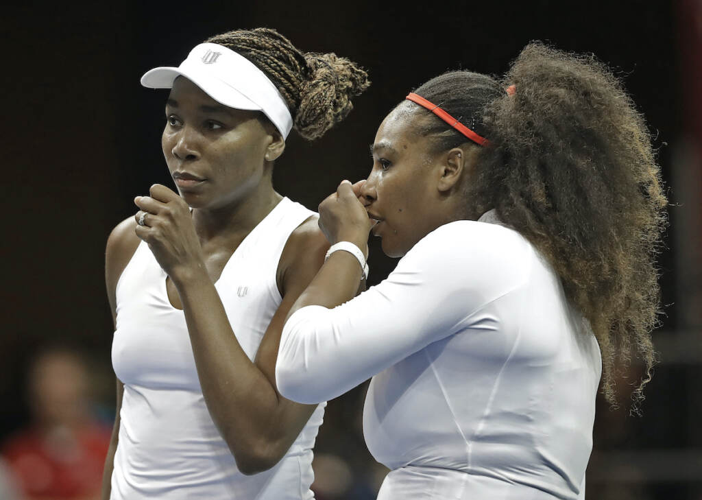 Venus Williams, Serena Williams In this Sunday, Feb. 11, 2018, file photo, USA's Venus Williams (left) and Serena Williams (right) talk between points in their doubles match against Netherlands' Leslie Herkhove and Demi Schuurs in the first round of Fed Cup tennis competition in Asheville, N.C. (AP Photo/Chuck Burton, File)