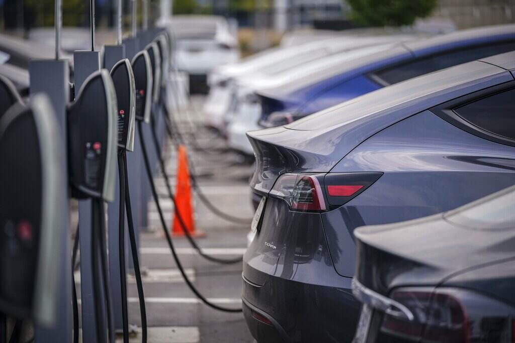 Electric Vehicles A group of cars line up at charging stations