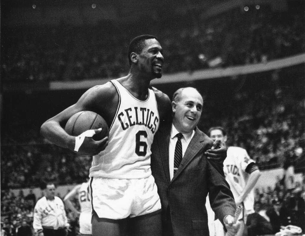 Obit-Bill Russell Basketball File photo: Bill Russell, (left) star of the Boston Celtics is congratulated by coach Arnold ''Red'' Auerbach after scoring his 10,000th point in the NBA game against the Baltimore Bullets in Boston Garden on Dec. 12, 1964. (AP Photo/Bill Chaplis, file)