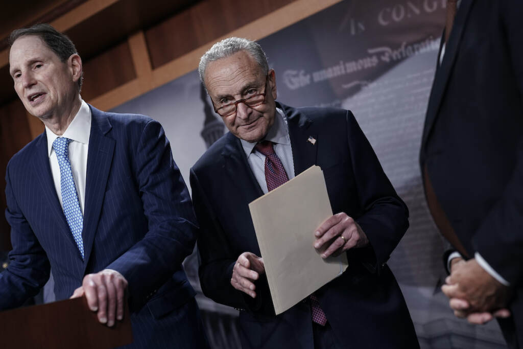 Chuck Schumer, Ron Wyden Senate Majority Leader Chuck Schumer, D-N.Y., joined at left by Senate Finance Committee Chair Ron Wyden, D-Ore., speaks to reporters after a closed-door policy meeting, at the Capitol in Washington, Tuesday, Aug. 2, 2022. (AP Photo/J. Scott Applewhite)